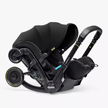 Black car seat with canopy on a white background