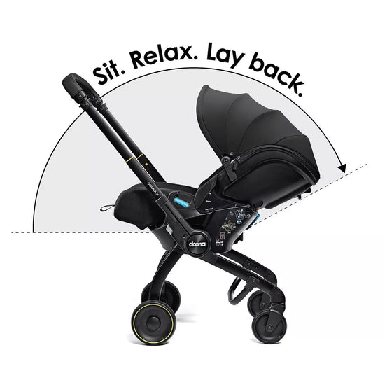 Black stroller with text 'Sit. Relax. Lay back.' on a white background