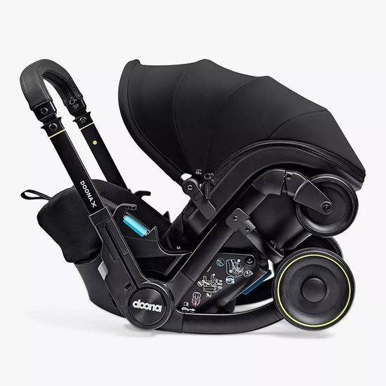 Black baby car seat with canopy on a white background