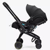 Black stroller with canopy on a white background